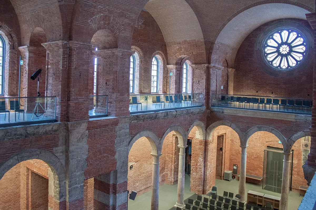 The interior of the Allerheiligen-Hofkirche in the Munich Residenz with bare brick vaults and domes above a long hall